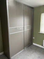 Fitted sliding wardrobes in Middlesbrough with stone grey wood and glass panels